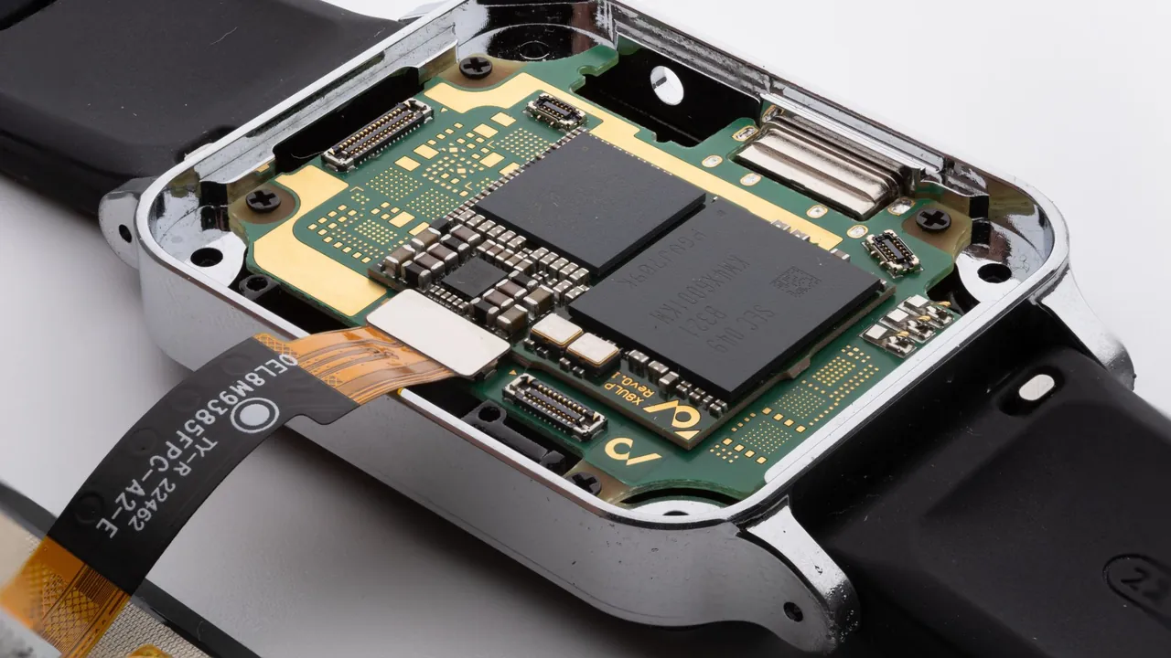 A smartwatch opened up, showing its main board inside the case